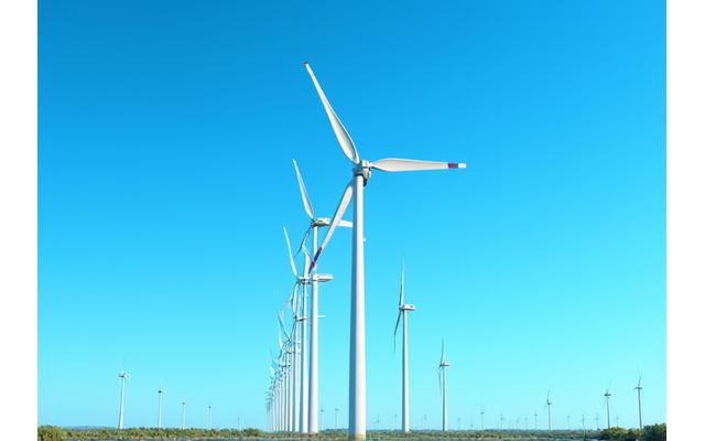 Moderne Windturbinen vor einem klaren blauen Himmel, die nachhaltige Energieerzeugung darstellen.